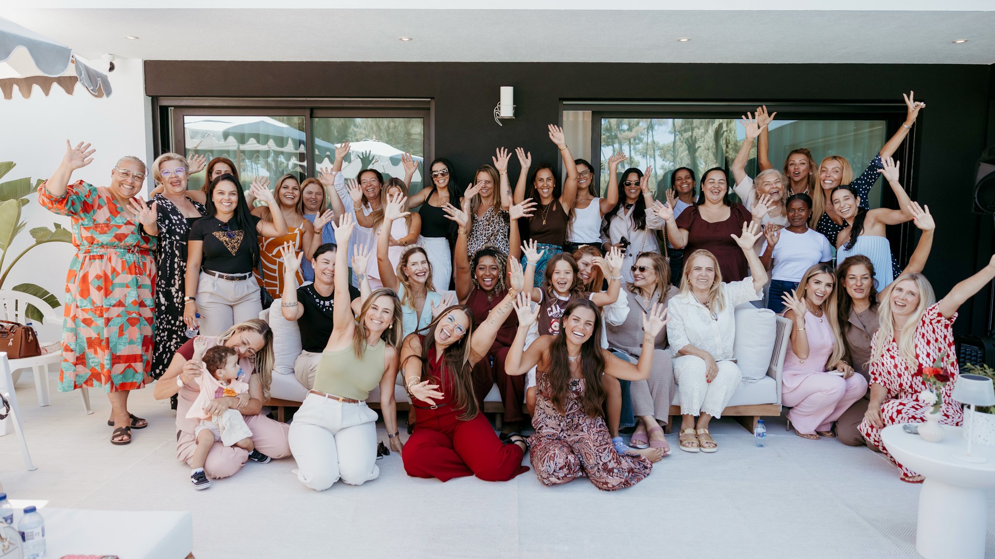 Mulheres do BRAVE reunidas num encontro, sorrindo e acenando para a foto